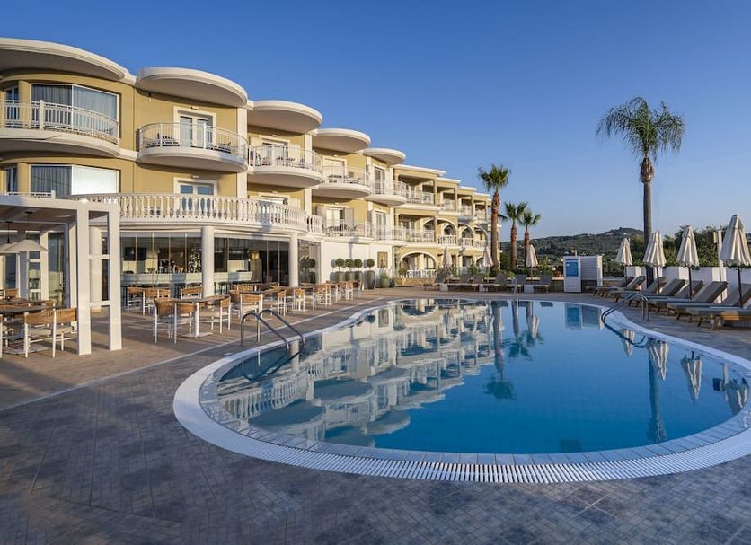 Arkadia Hotel in Tsilivi with a curved outdoor pool, sun loungers, and seaside hotel terraces