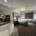 AmericInn by Wyndham Galesburg room with king bed, jetted tub, and window with closed shade