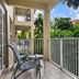 Club Wyndham Sea Gardens balcony with chairs overlooking lush tropical greenery in Pompano Beach