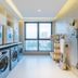 Binhai Jianguo Hotel in Tianjin laundry room with washers, dryers and large city-view window