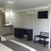 Hotel Graham Villahermosa room with two beds, desk, chair, wall TV and wardrobe in Villahermosa