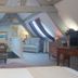 Hôtel Spa - Au Charme Rabelaisien attic suite in Amboise with sloped ceilings, sofa and desk