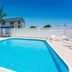 Pool area at Fairfield Inn & Suites by Marriott Corpus Christi with loungers, umbrella, and palm trees