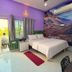 Anukampa Paying Guest House in Agra room with bed, mural wall, balcony doors and air conditioner