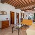 Le Rocche di Valiano in Vagliagli, rustic lounge with exposed beams and sofa seating