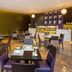 Flora Park Deluxe Hotel Apartments in Dubai dining area with set tables and marble buffet counter