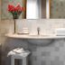 Relais Le Betulle Conegliano bathroom vanity with mirror, sink, and red flowers