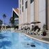 The Heritage Grand Khon Kaen Hotel and Convention poolside with loungers and palm trees in Khon Kaen