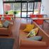 Parque de Campismo Orbitur Vagueira lounge with sofas, tables, and glass doors overlooking the grounds