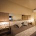 Hotel Cabanas Alto Da Serra room in Canela with double bed, bedside lamps, mirror, and mini fridge