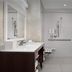 Home2 Suites by Hilton Lake City bathroom with roll-in shower, vanity, and shower seat