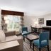 La Quinta Inn & Suites by Wyndham Bakersfield North guest room with desk, seating area, TV and window view