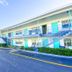 Uptown Inn & Suites in St. Petersburg exterior with two-story motel-style walkway and parking lot