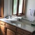Maxwelton Braes Lodge Baileys Harbor bathroom vanity with sink, mirror, and window light