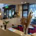 Sky Hotel Matsuyama lobby with polished floors, seating area, glass entrance, and city-view windows