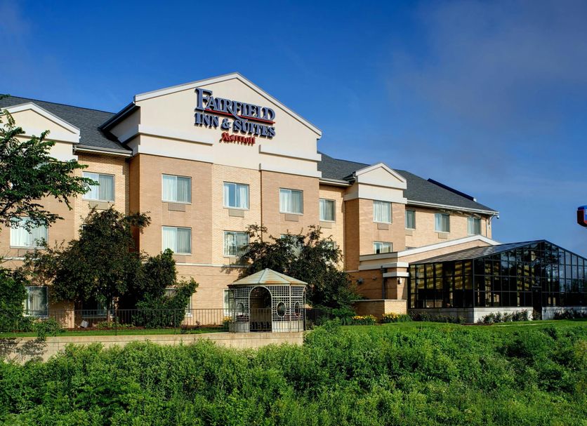 Fairfield Inn & Suites by Marriott Indianapolis East exterior in Indianapolis with landscaped grounds and glass atrium