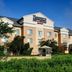 Fairfield Inn & Suites by Marriott Indianapolis East exterior in Indianapolis with landscaped grounds and glass atrium