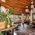Il Mondo Boutique Hotel Brisbane dining area with wooden ceiling, lanterns, tables and potted plants