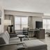 Residence Inn by Marriott Davenport suite with sofa, desk, bed, and dining table in a bright room