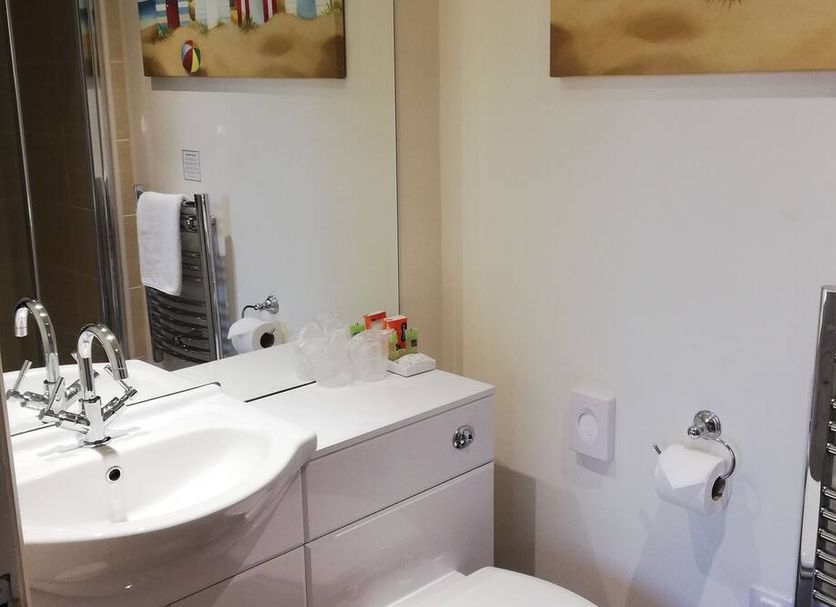 The Claremont, Woodhall Spa: hotel bathroom with sink vanity, mirror, towel rack and toilet paper holder
