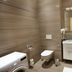 Residence U Cerne Veze bathroom with bathtub, sink, toilet and washing machine in České Budějovice