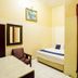 Casavilla Travellers Lodge Pudu in Kuala Lumpur room with bed, chair, table and wooden door