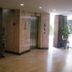 Suriwongse Hotel Bangkok lobby with elevator, marble floors, and potted plant by windows