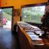 Pousada Atalaia in Campos do Jordão with reception desk and large window view of greenery
