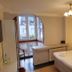 Hotel am Markt Saarburg guest room with double bed and arched window overlooking town