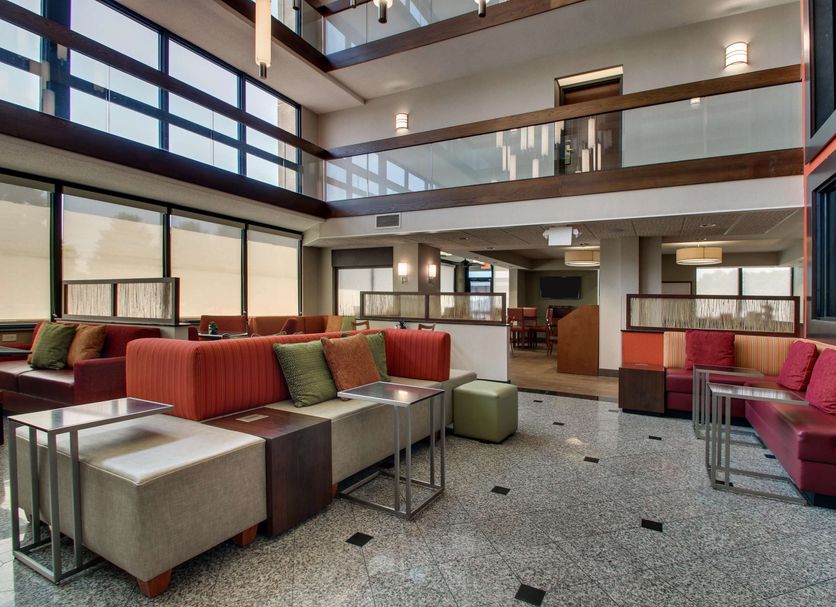 Lobby seating area at Drury Inn & Suites Evansville East in Evansville with modern couches and high ceilings