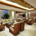 Gentl Grown Sanya Seashore lobby lounge with wicker seating and warm ceiling lighting in Sanya