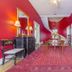 Bourbon Manor Bed & Breakfast Inn in Bardstown, elegant red hallway with ornate mirror and antique bench