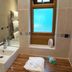 The Carrington Arms in Newport Pagnell bathroom with sink, bathtub, wooden ledge and frosted window