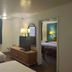 Motel 6 Portland, IN room with two beds, TV dresser, lamp, window, and adjoining bedroom doorway