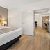 Country Inn & Suites by Radisson, Roanoke, VA guest room with king bed and open doorway to workspace