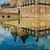 Romantik Parkhotel Wasserburg Anholt in Isselburg reflected in a calm moat beside a historic brick castle