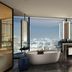Hilton Saigon in Ho Chi Minh City bathroom with city skyline view, freestanding tub and vanity