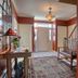 Annville Inn Bed and Breakfast in Annville entry hall with bench, rug, front door and red walls