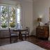 La Dimora Dei Monaci Siena room with fireplace, window view, and small table set