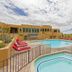 Gold Canyon Golf Resort in Gold Canyon: outdoor pool with hot tub, red loungers, and desert resort views