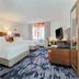 Fairfield Inn & Suites by Marriott Houston Westchase guest room with two beds, TV, desk and coffee station