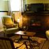 Gatekeeper's Retreat in Niagara-on-the-Lake living room with fireplace, armchairs, and coffee table