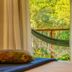 Pousada Ecoilha in Ilhabela with a hammock-lined balcony view through curtained windows