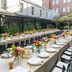 Emeline Charleston outdoor dining setup with long tables, floral centerpieces, and patio seating
