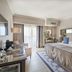 Dona Filipa Hotel in Almancil guest room with king bed, balcony doors, and ocean-style patterned headboard