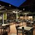 Hotel Bieze Borger outdoor terrace with tables, chairs and large umbrellas at dusk
