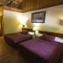 Black Bear Lodge Motel in Slade: rustic double room with two beds, wood ceiling and warm lamps