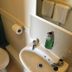 The Kings Arms London bathroom with toilet, sink, mirror, and towel rack