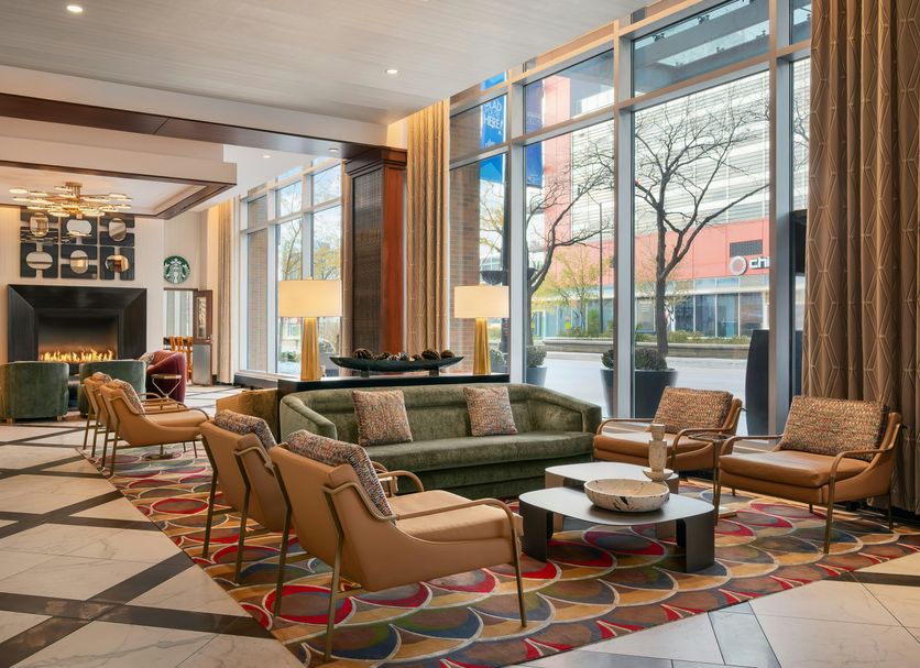 Home2 Suites by Hilton Chicago McCormick Place lobby seating area with large windows and fireplace