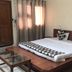 Goroomgo Mourya Inn Madhya Pradesh room with bed, bedside lamps, curtains and glass coffee table in Harda
